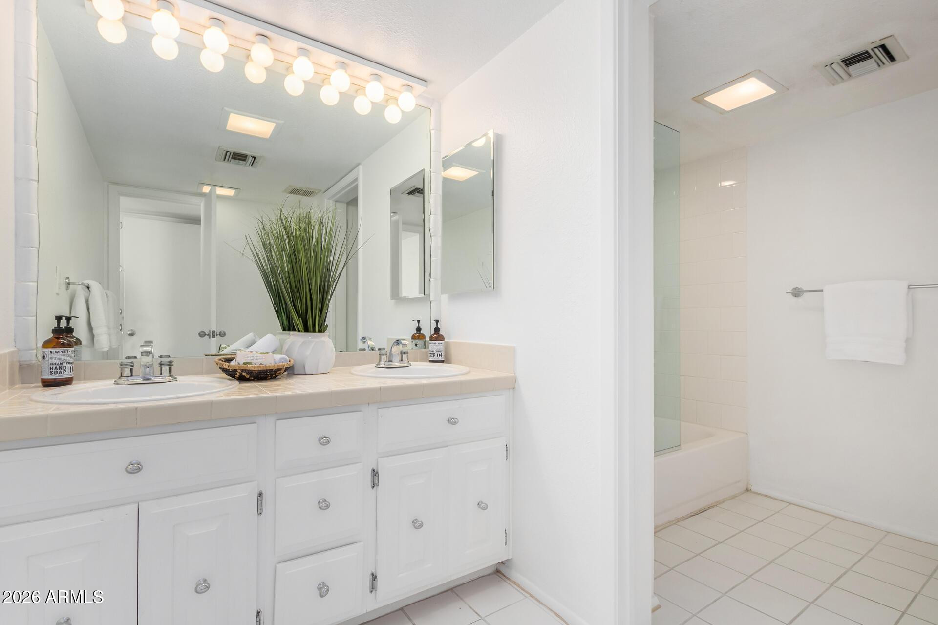 4656 North 40th Street Phoenix, AZ 85018 - Photo 19 of 28 a bathroom with a double vanity sink and a mirror