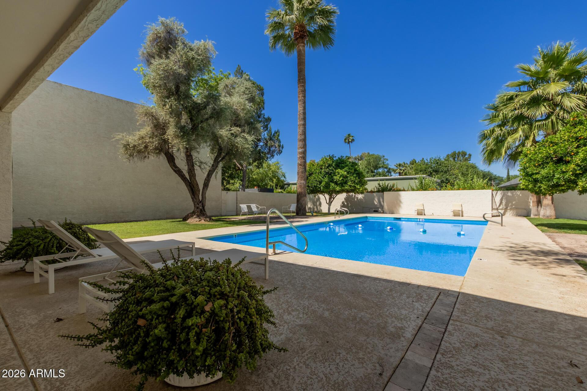 4656 North 40th Street Phoenix, AZ 85018 - Photo 22 of 28 a view of a swimming pool with a bench