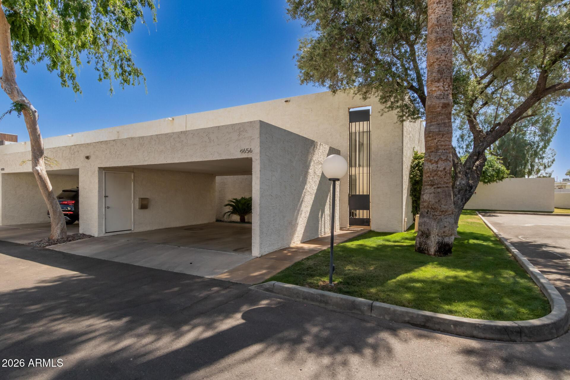 4656 North 40th Street Phoenix, AZ 85018 - Photo 4 of 28 a front view of a house with a yard and garage