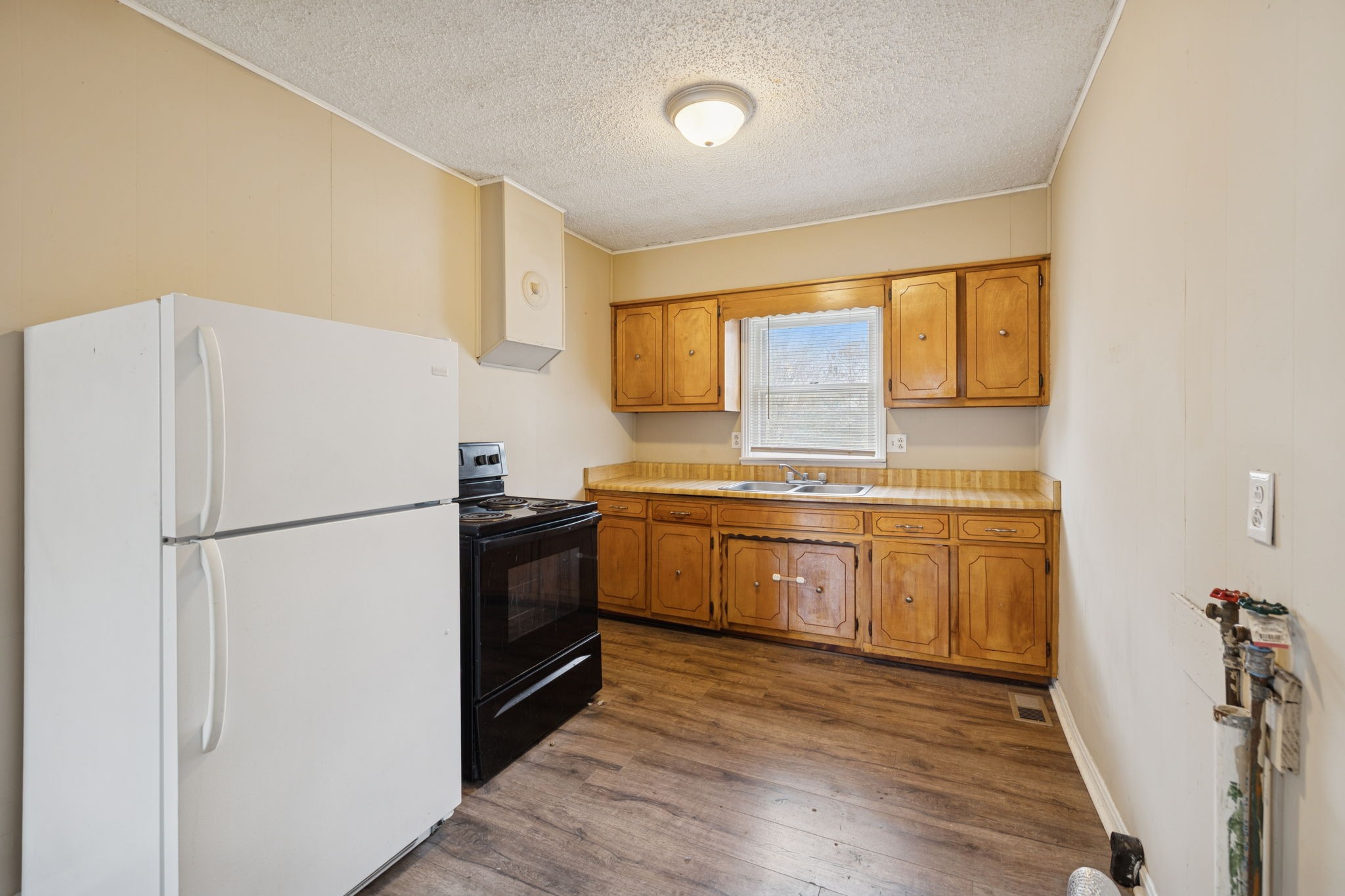 1323 Pleasant Grove Road Westmoreland, TN 37186 - Photo 12 of 26 a kitchen with a refrigerator sink and cabinets