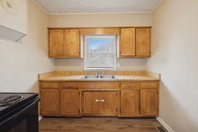 a kitchen with a sink and cabinets