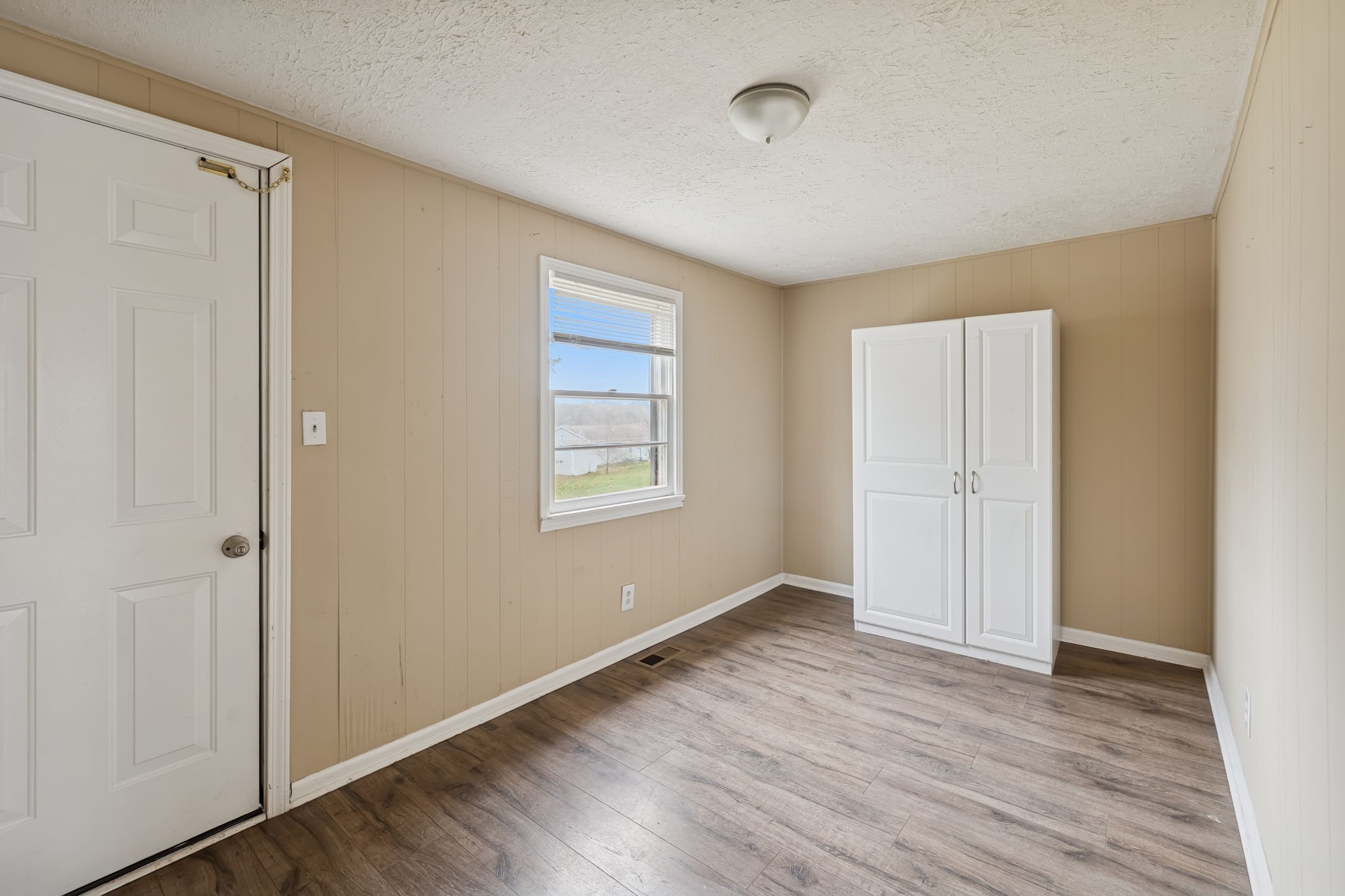 1323 Pleasant Grove Road Westmoreland, TN 37186 - Photo 20 of 26 a view of an empty room with wooden floor and a window