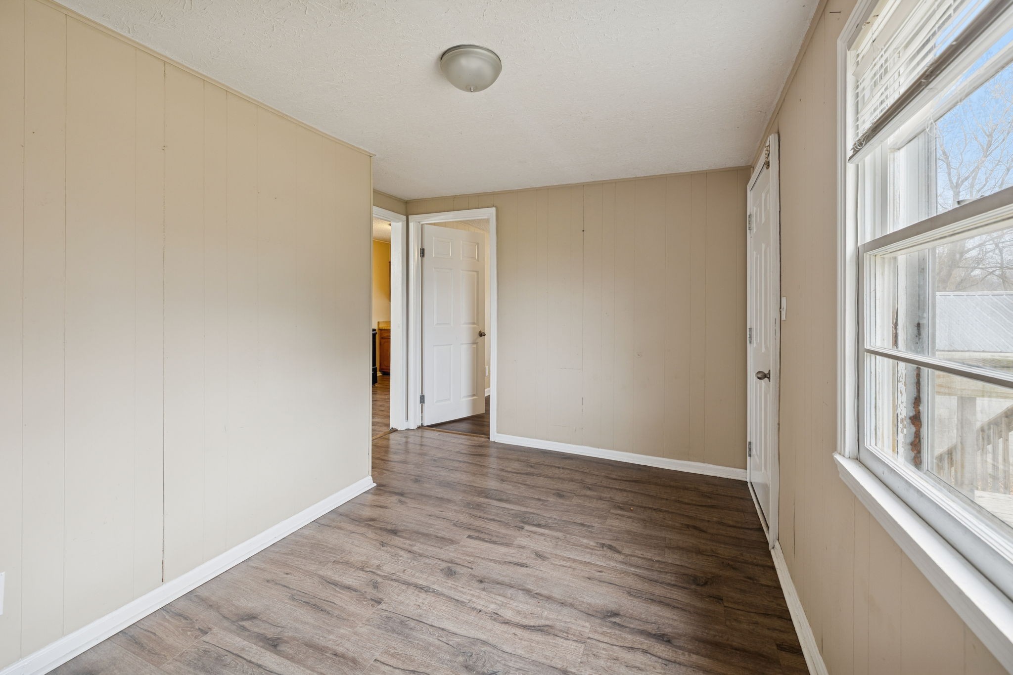 1323 Pleasant Grove Road Westmoreland, TN 37186 - Photo 21 of 26 a view of an empty room with wooden floor and a window