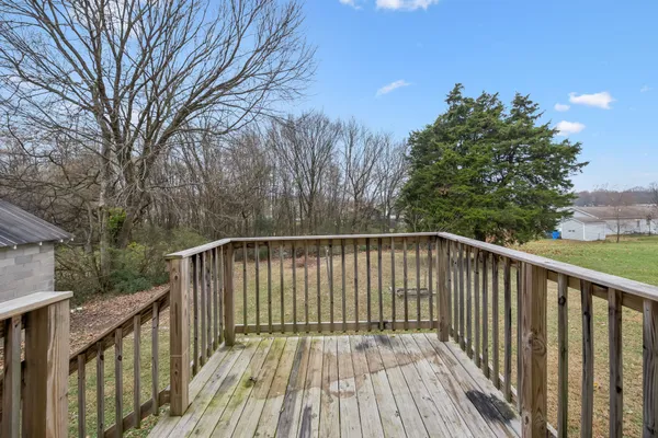 a balcony with wooden floor and fence