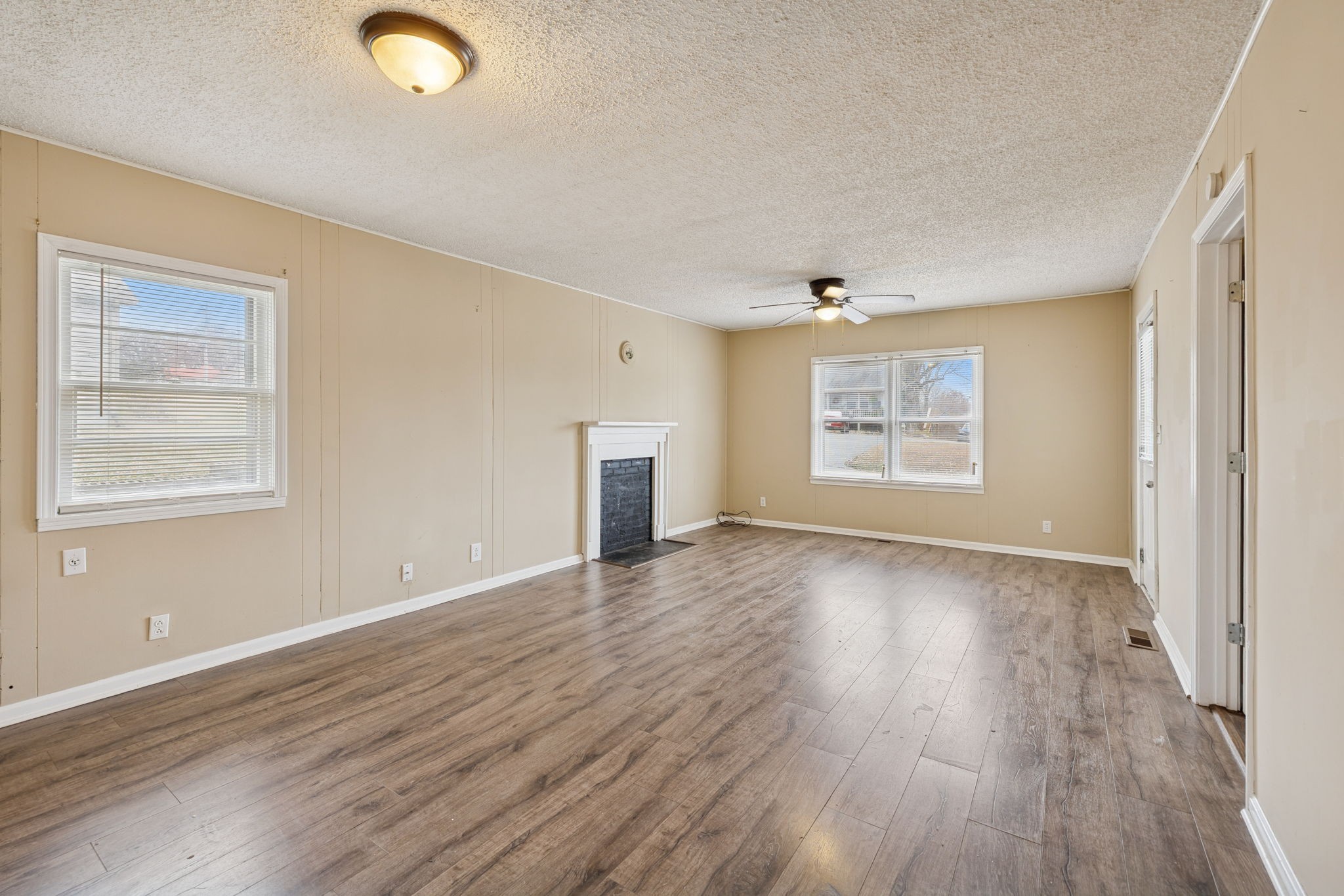 1323 Pleasant Grove Road Westmoreland, TN 37186 - Photo 7 of 26 an empty room with wooden floor and windows