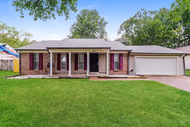 a view of a house with a yard porch and sitting area