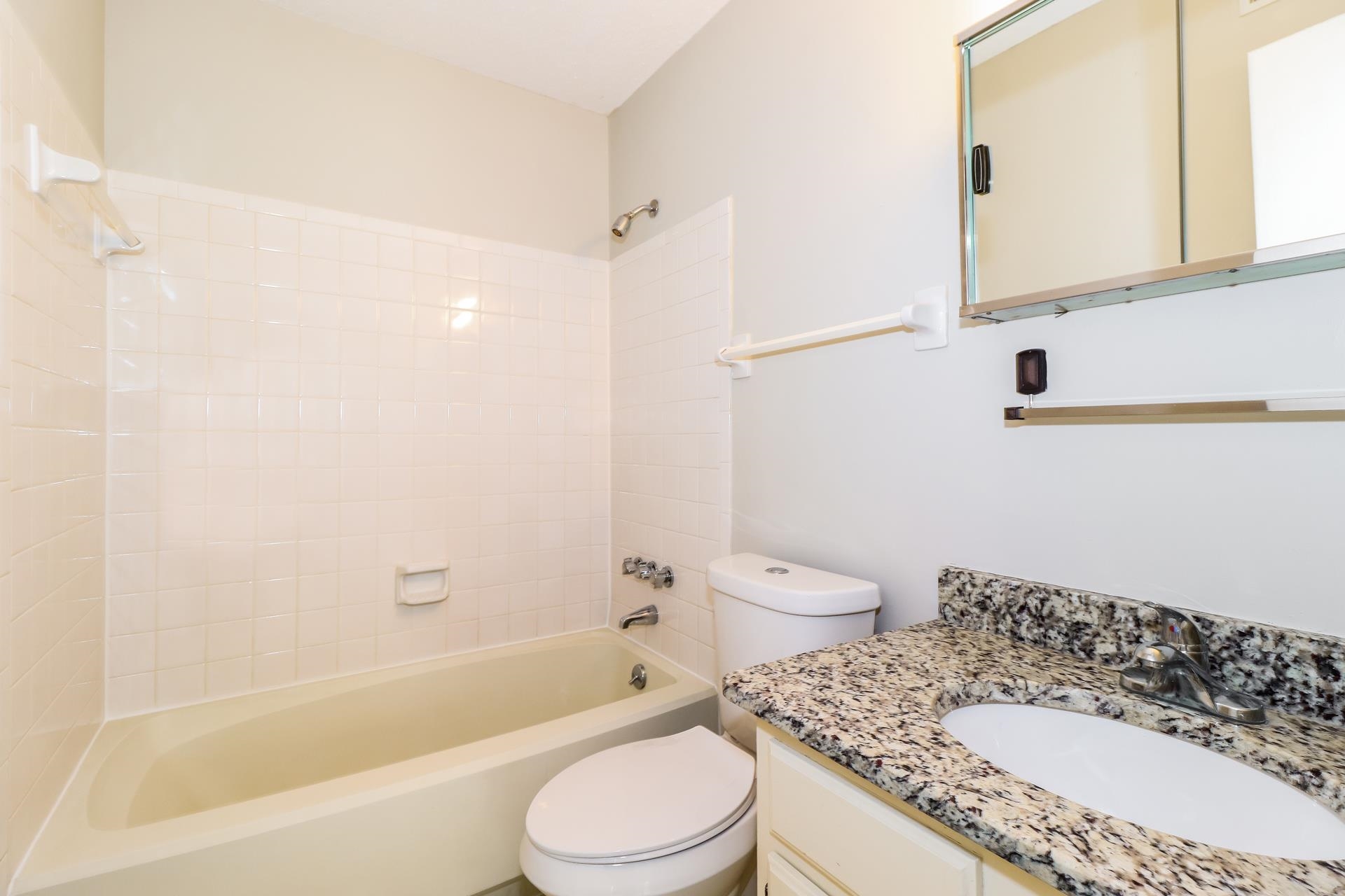 2145 Bobolink Trail Memphis, TN 38134 - Photo 13 of 16 a bathroom with a granite countertop sink a toilet and bathtub