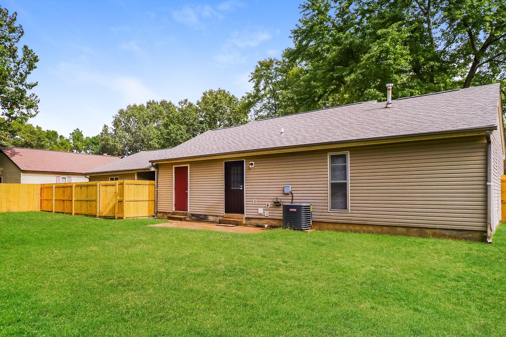 2145 Bobolink Trail Memphis, TN 38134 - Photo 15 of 16 a backyard of a house with table and chairs