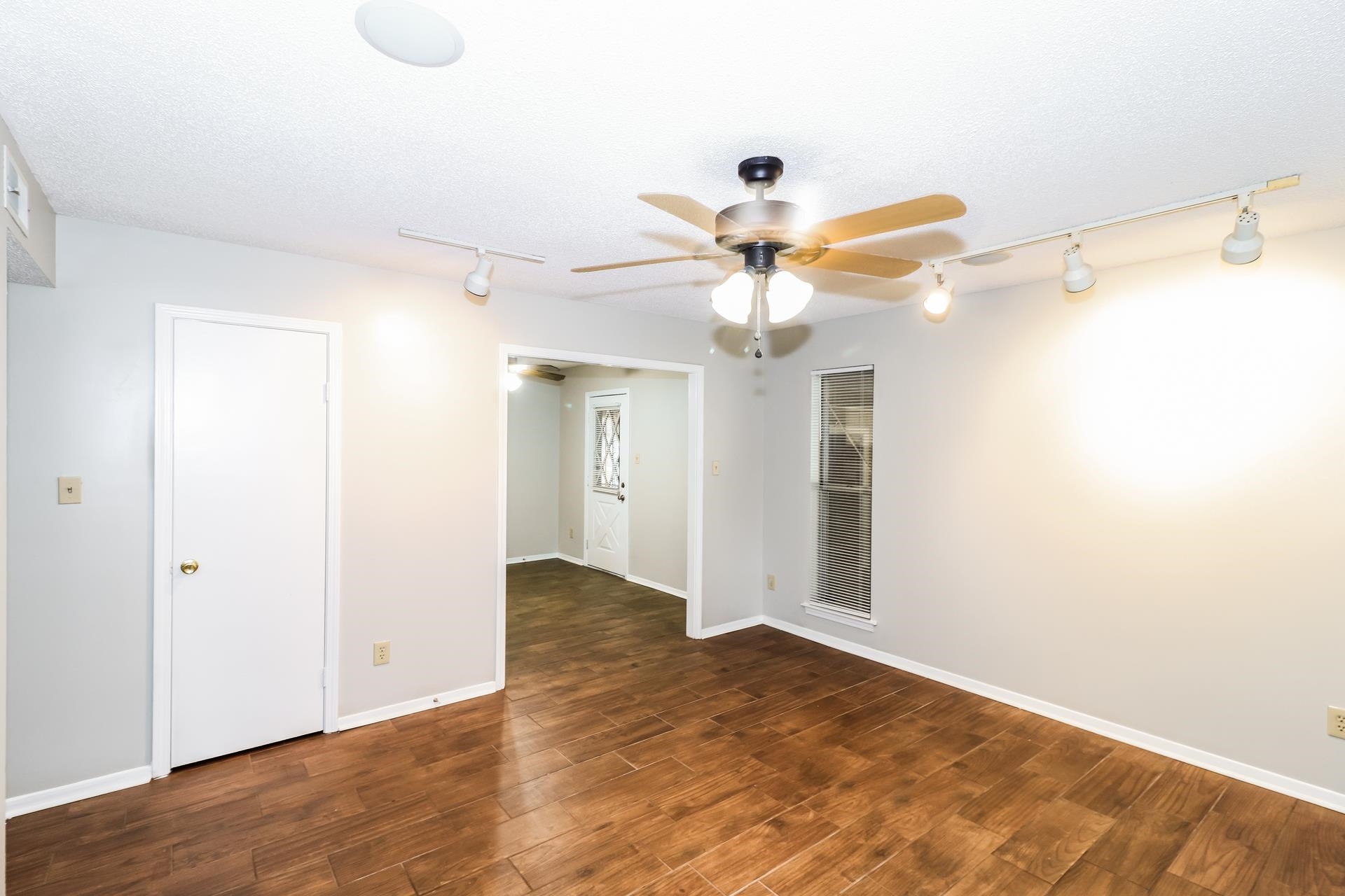 2145 Bobolink Trail Memphis, TN 38134 - Photo 3 of 16 an empty room with wooden floor and a ceiling fan