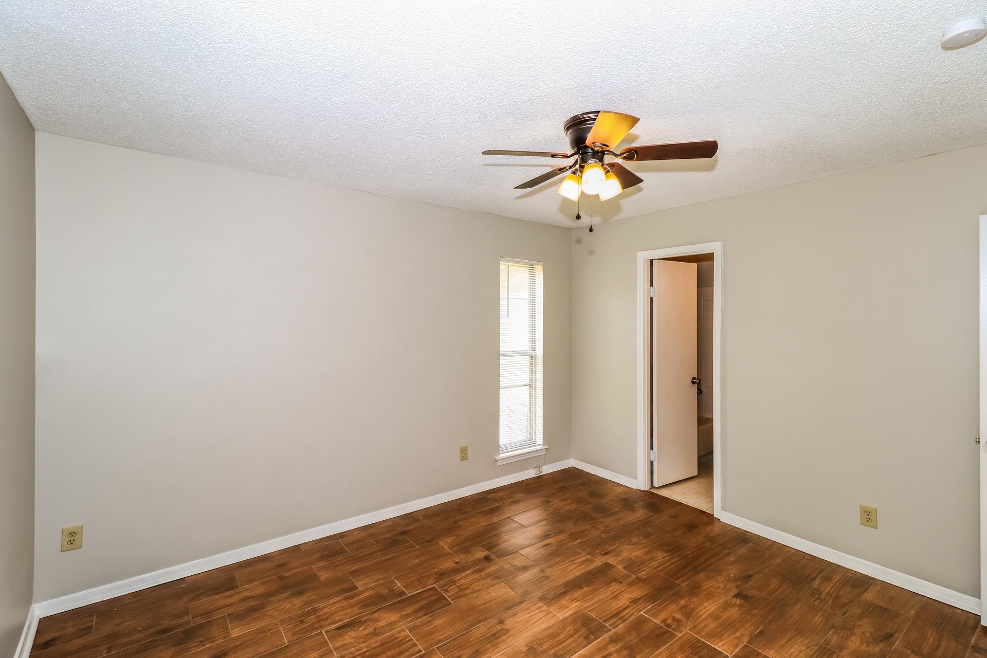 2145 Bobolink Trail Memphis, TN 38134 - Photo 9 of 16 a view of a chandelier fan and hardwood floor