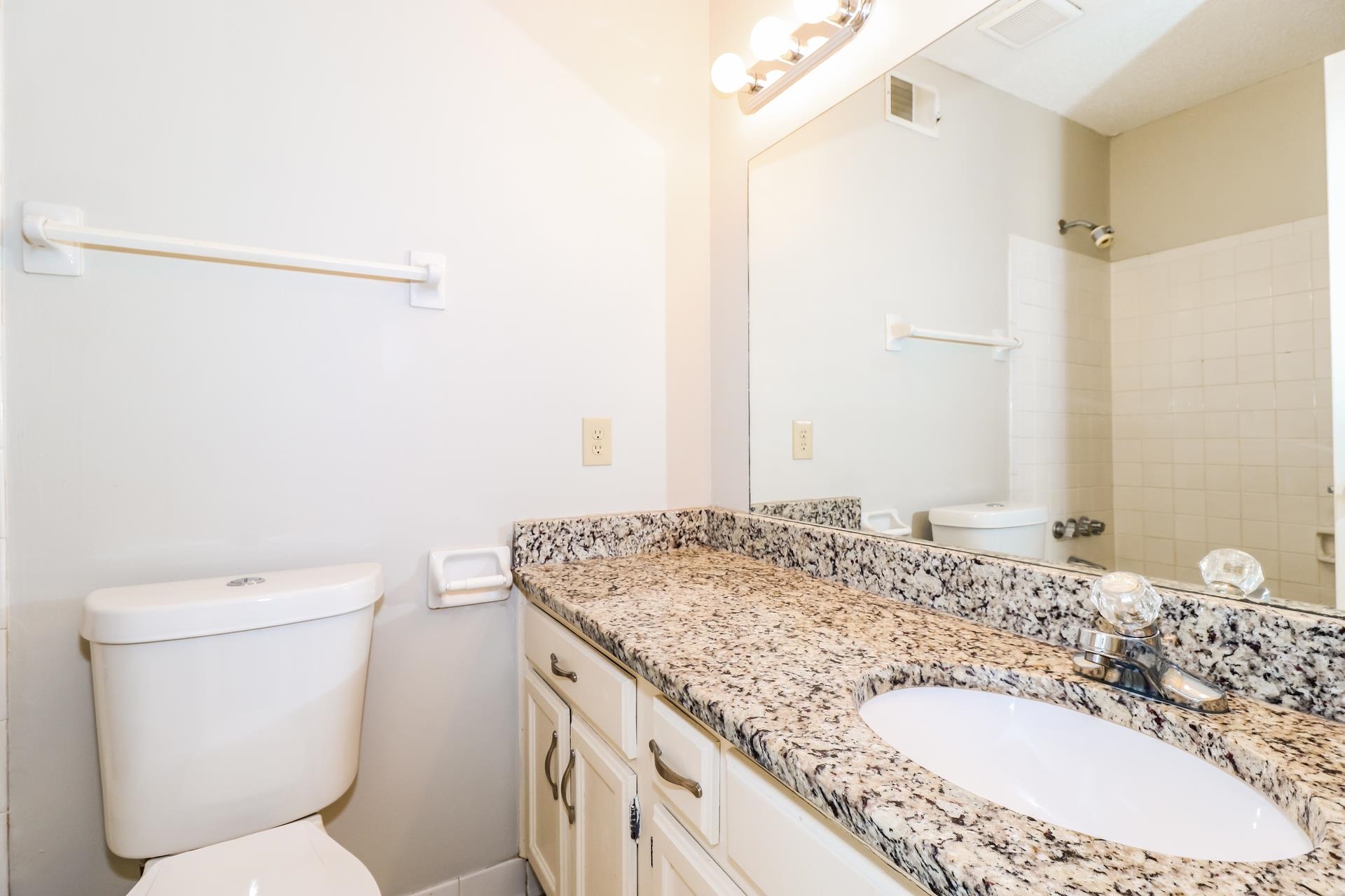 2145 Bobolink Trail Memphis, TN 38134 - Photo 10 of 16 a bathroom with a granite countertop sink a toilet and a mirror