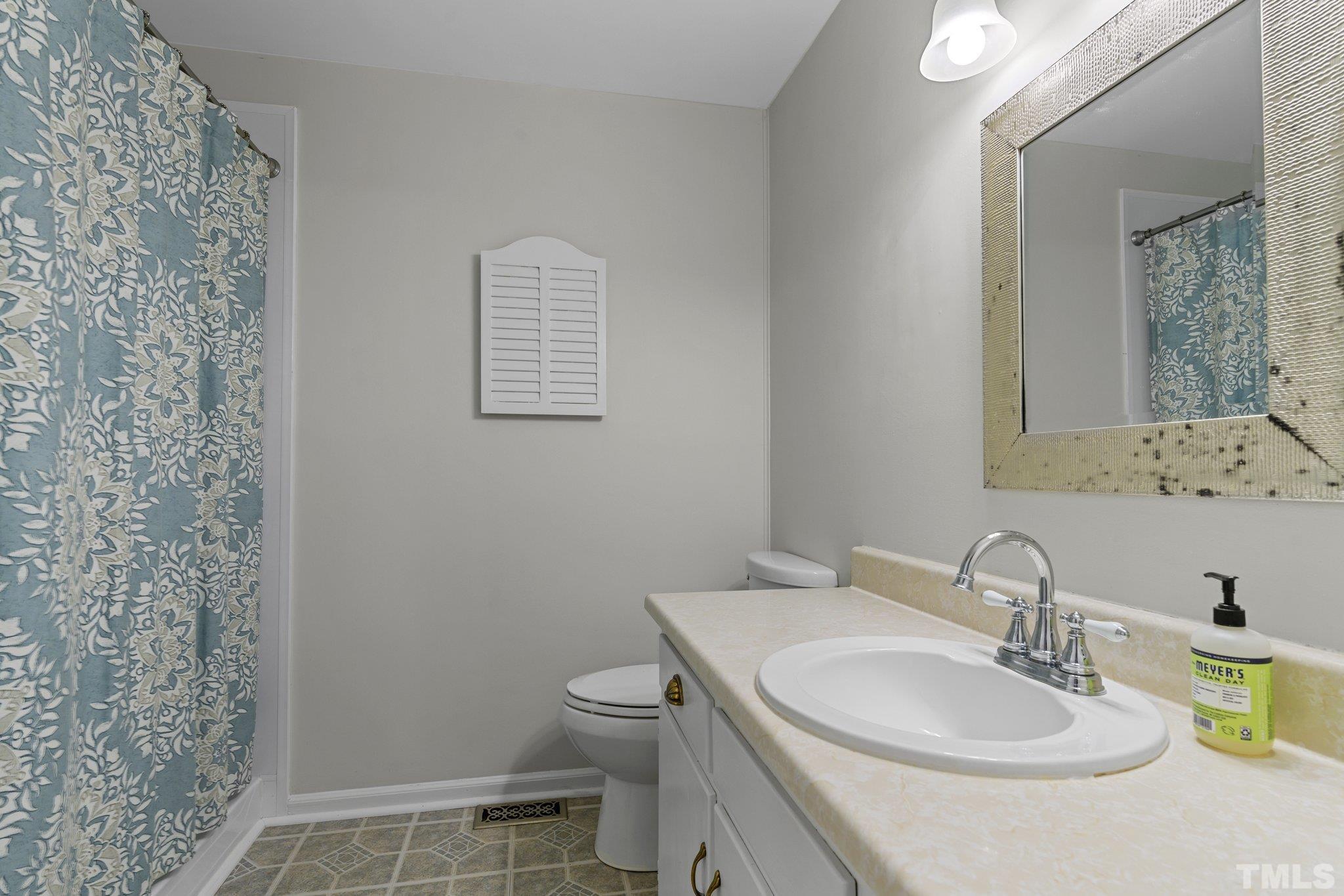 1502 Edgeside Court Raleigh, NC 27609 - Photo 13 of 27 Primary Bathroom with walk in shower and lots of extra counter space and storage.