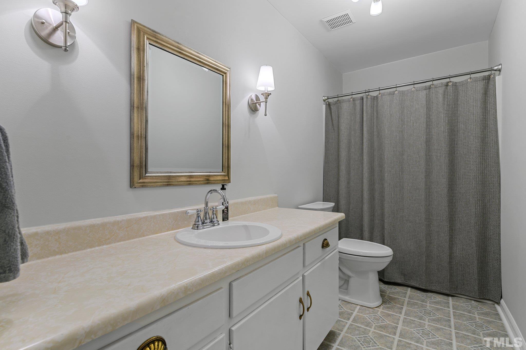 1502 Edgeside Court Raleigh, NC 27609 - Photo 17 of 27 Full Bathroom with tub/shower in hallway. Linen closet in hall as well.
