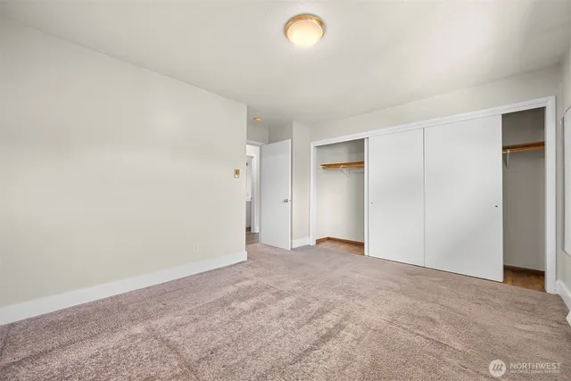 an empty room with closet area