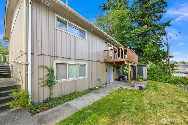 a backyard of a house with outdoor seating and a garden
