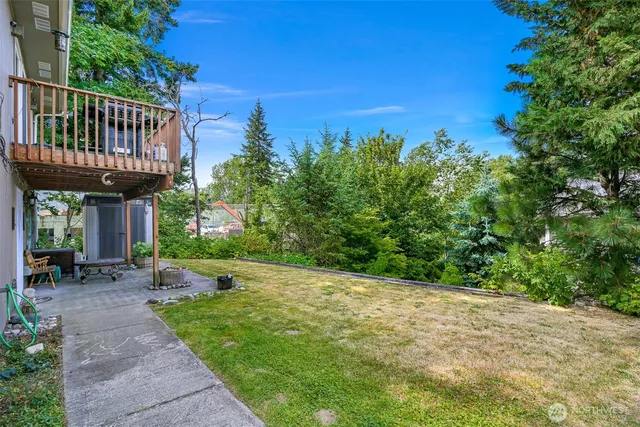a view of a backyard with sitting area and garden