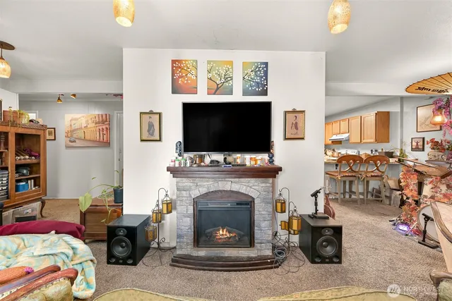 a living room with furniture a flat screen tv and a fireplace