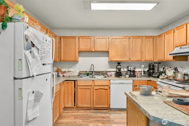 a kitchen with a sink stove top oven and cabinets