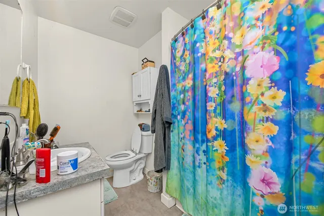 a white house covered with tall trees