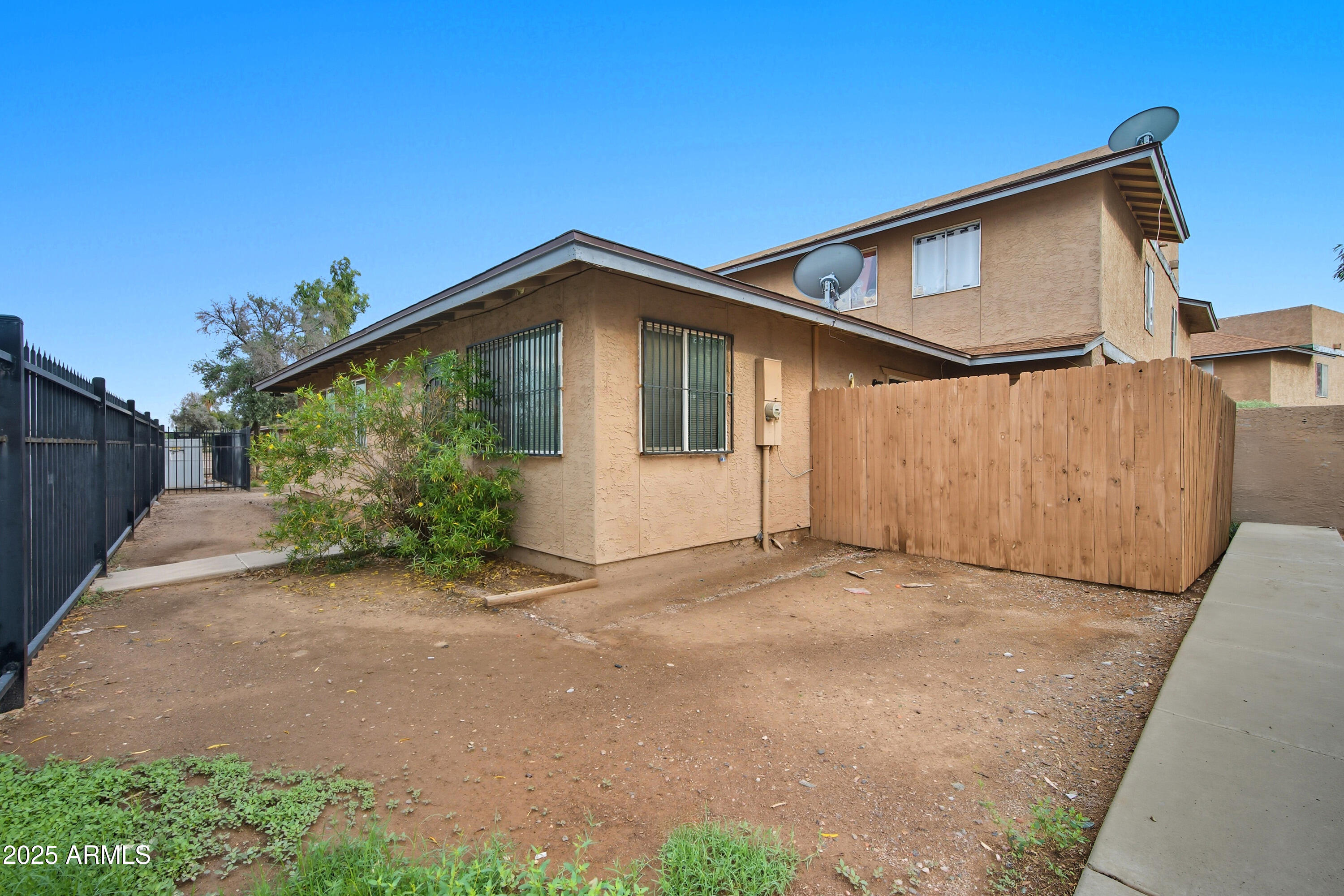 4242 North 69th Lane, Unit 1333 Phoenix, AZ 85033 - Photo 1 of 18 a front view of a house with a yard and garage