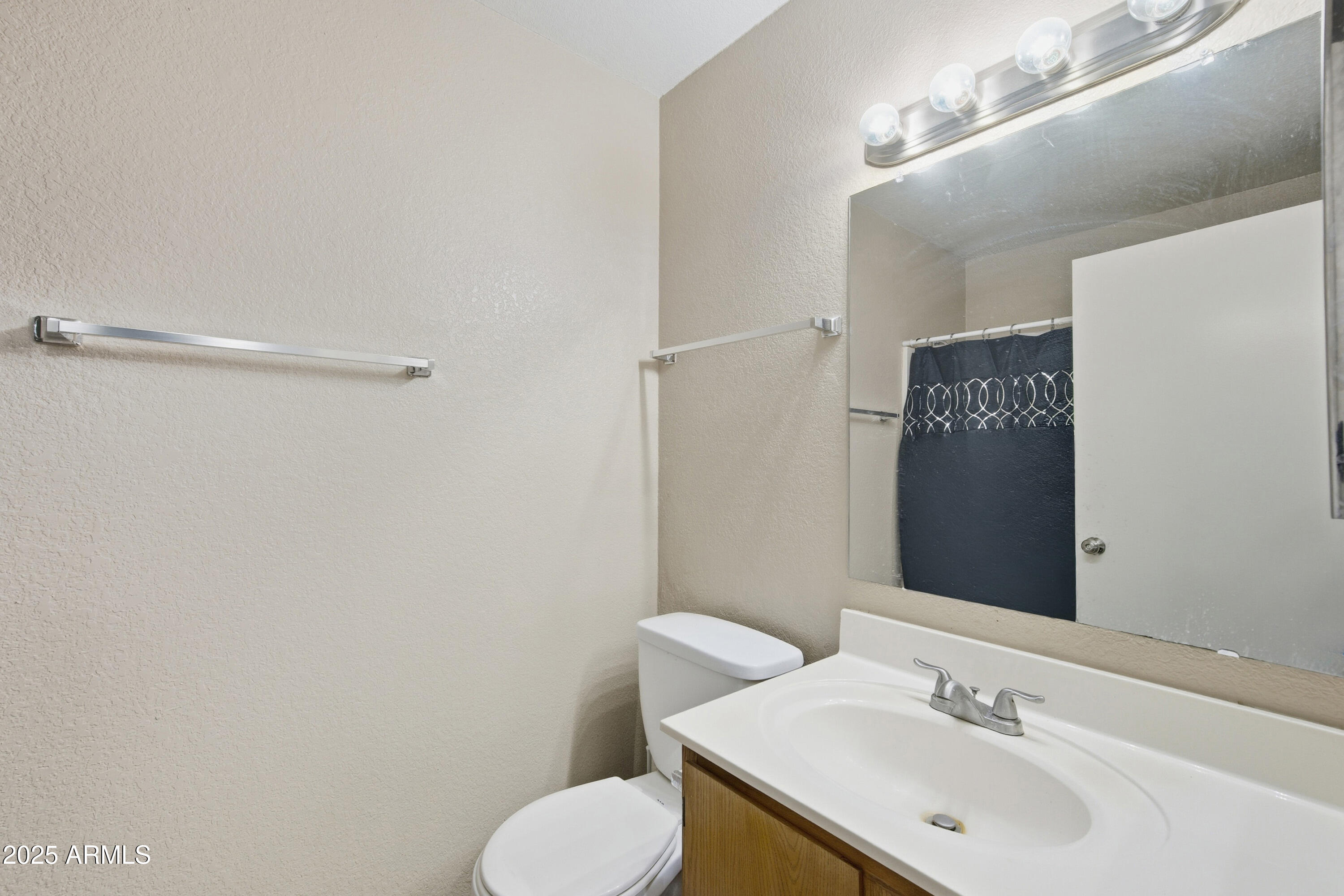 4242 North 69th Lane, Unit 1333 Phoenix, AZ 85033 - Photo 16 of 18 a bathroom with a sink toilet and vanity