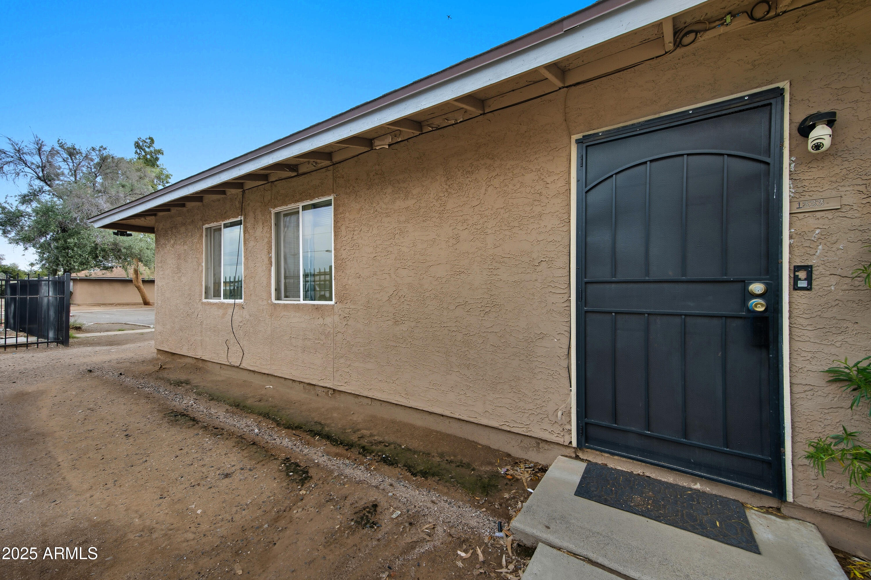 4242 North 69th Lane, Unit 1333 Phoenix, AZ 85033 - Photo 2 of 18 a backyard of a house