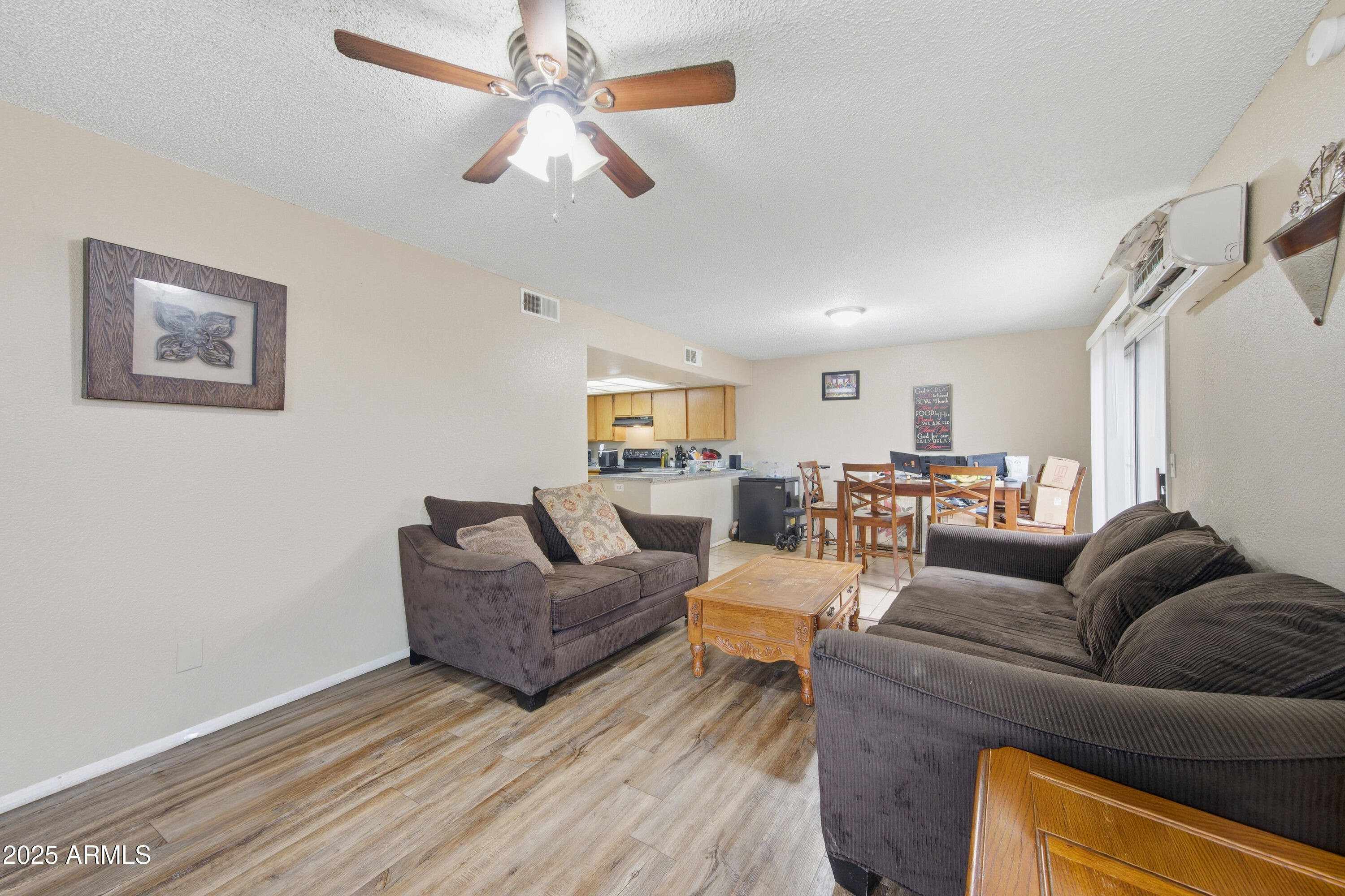 4242 North 69th Lane, Unit 1333 Phoenix, AZ 85033 - Photo 5 of 18 a living room with furniture and a wooden floor