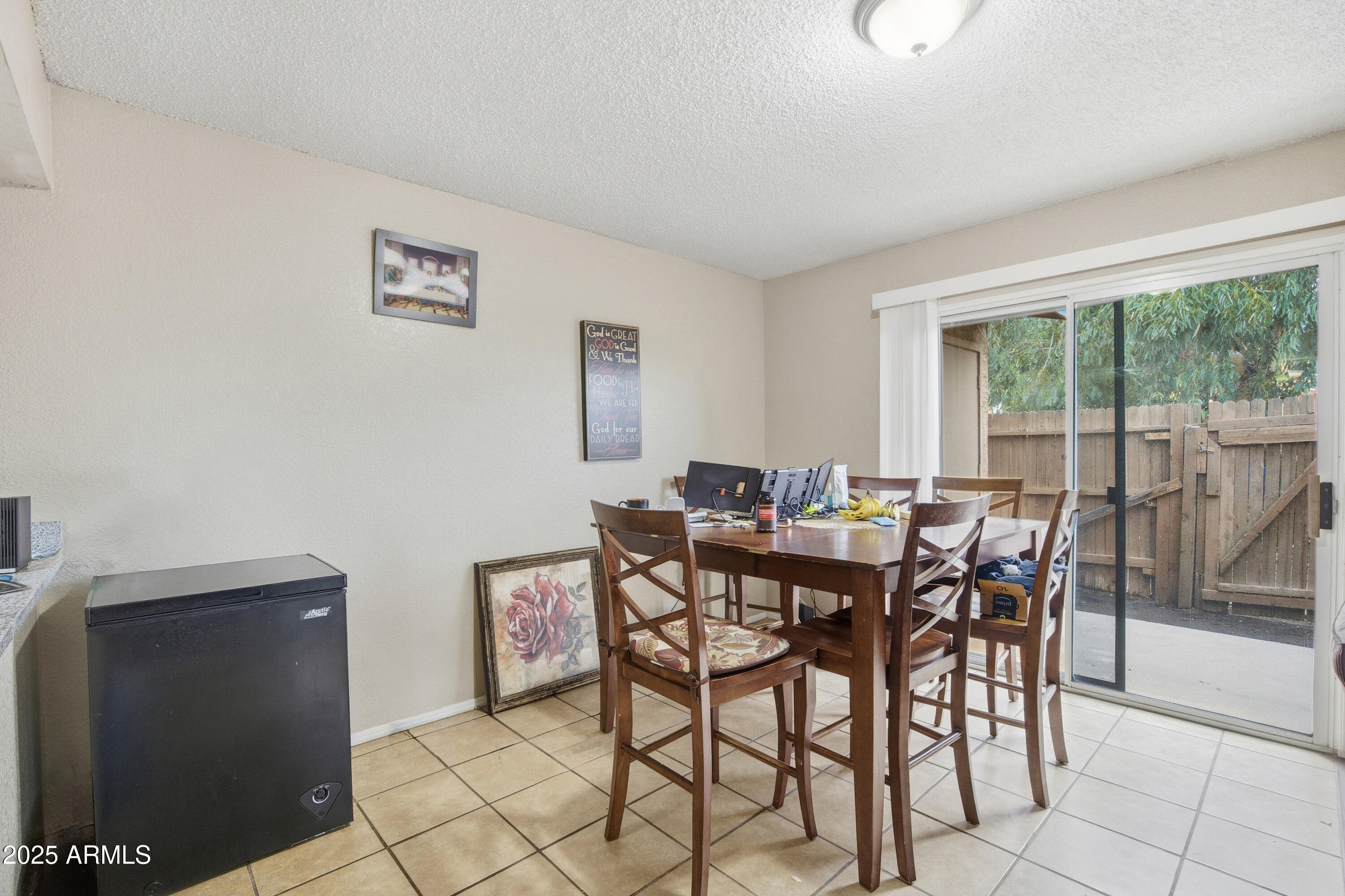 4242 North 69th Lane, Unit 1333 Phoenix, AZ 85033 - Photo 6 of 18 a view of a dining room with furniture and a potted plant