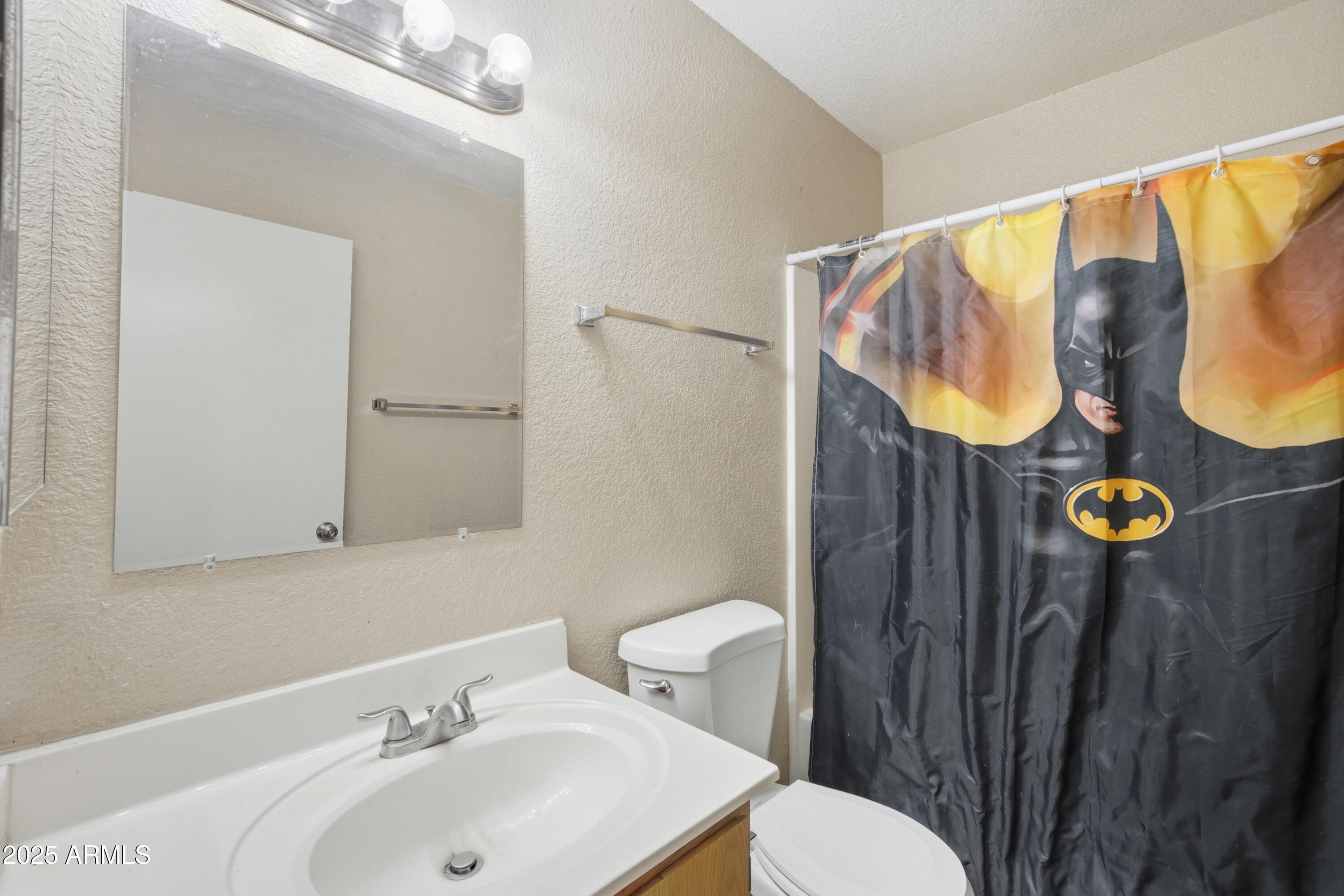 4242 North 69th Lane, Unit 1333 Phoenix, AZ 85033 - Photo 10 of 18 a bathroom with a sink and mirror
