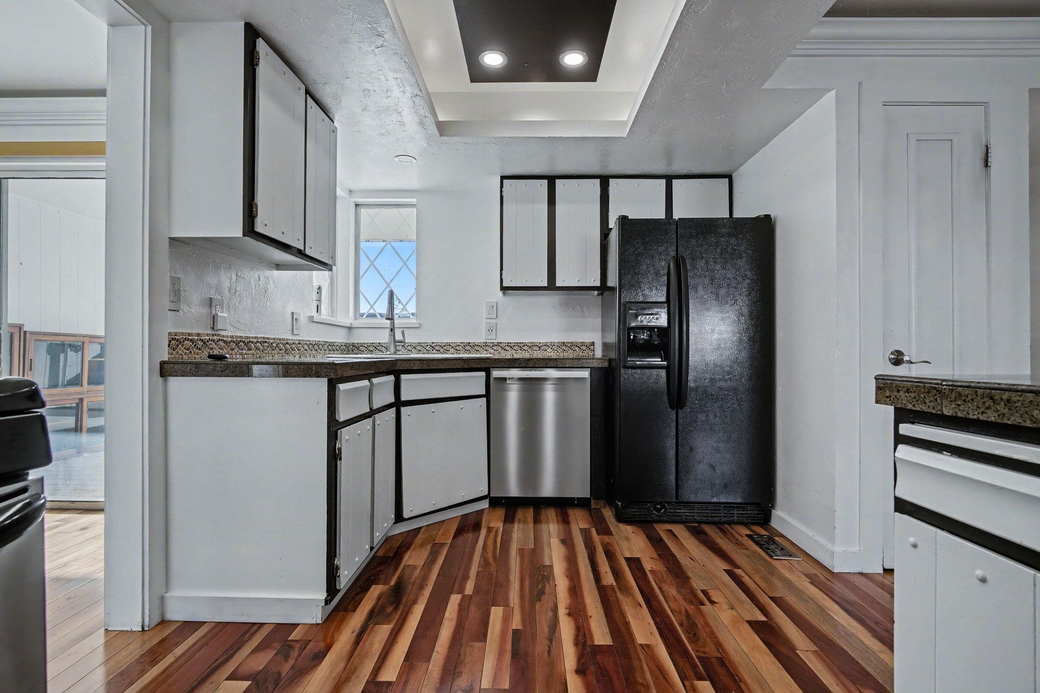 2700 G Road, Unit 12F Grand Junction, CO 81506 - Photo 7 of 24 a kitchen with stainless steel appliances a refrigerator and wooden floor