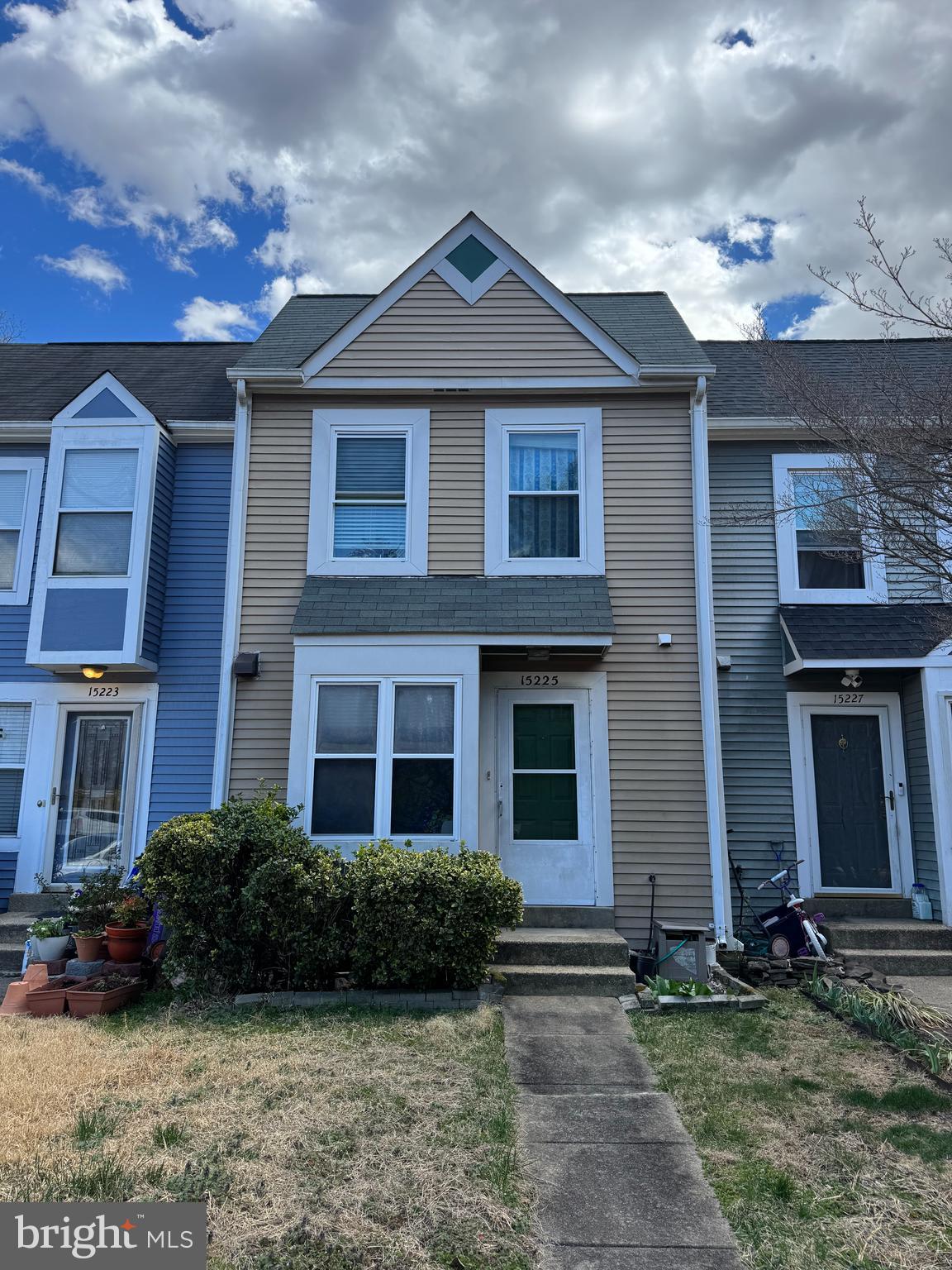 a front view of a house with yard and green space