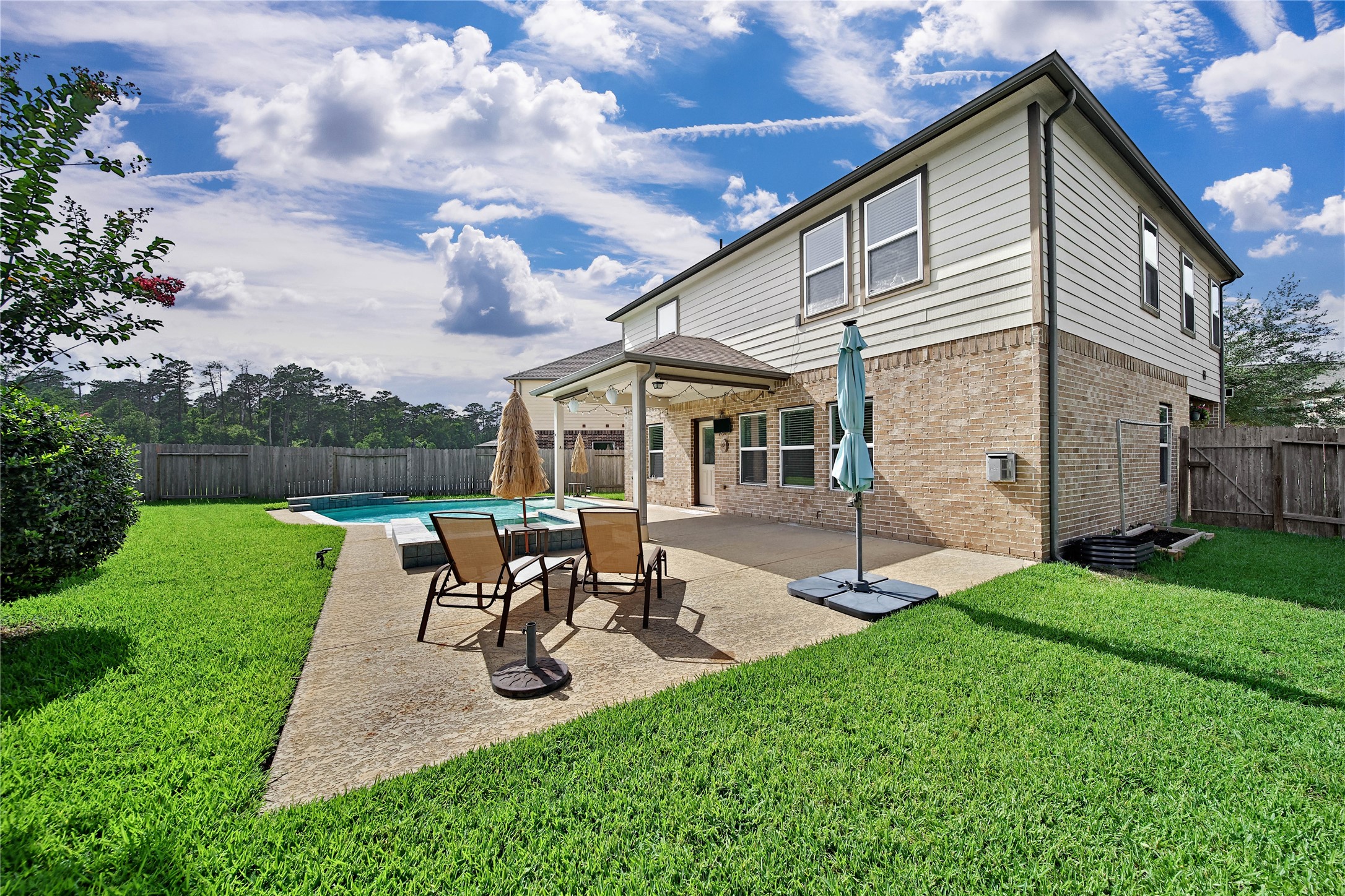 2672 Magnolia Fair Way Spring, TX 77386 - Photo 31 of 49 Lounge in the sun by the pool with on the extended pool deck. There's a gas line available here for your grill or generator. The large side yard means you will have plenty of grassy space where the kiddos and pets can play.
