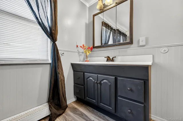 a bedroom with a bed and a flat tv screen on dresser