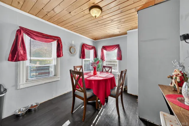 a dining room with furniture wooden floor and a chandelier