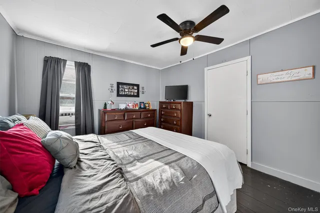 a living room with a balcony furniture and a flat screen tv