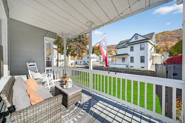 a kitchen with stainless steel appliances kitchen island granite countertop a refrigerator a stove top oven a sink dishwasher and wooden cabinets with wooden floor