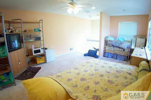 161 Nebula Road Piscataway, NJ 08854 - Photo 8 of 8 a bed room with a bed and a chair