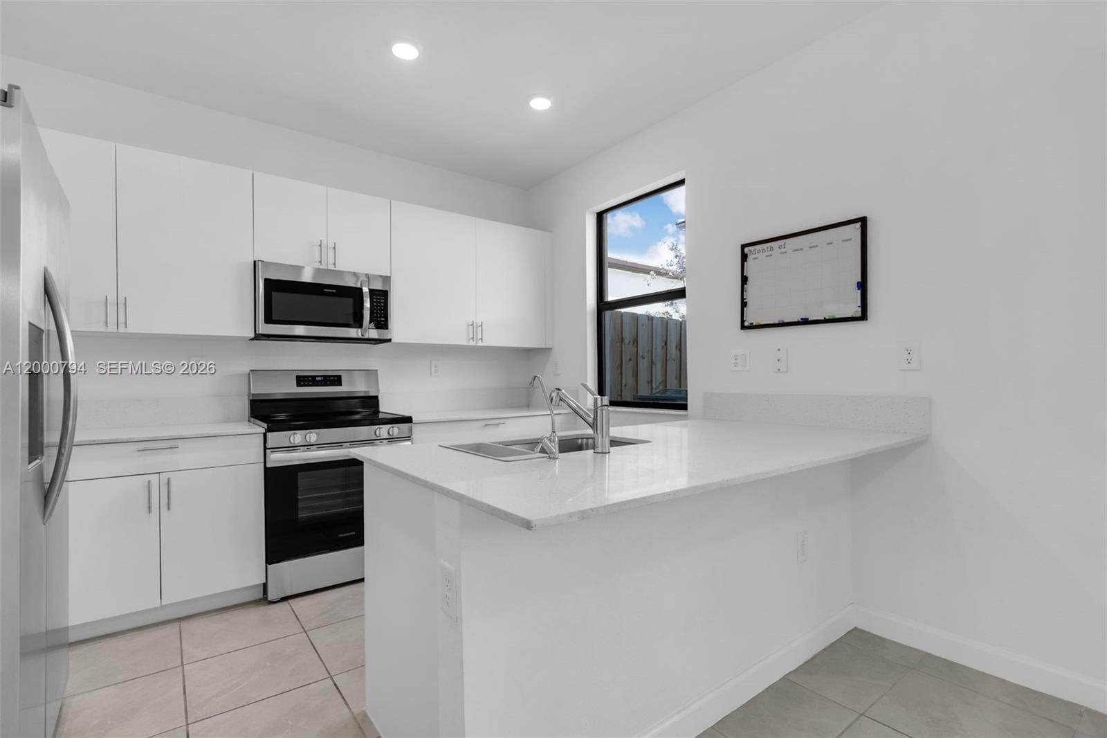 23077 Southwest 129th Place Miami, FL 33177 - Photo 12 of 43 a kitchen with cabinets and stainless steel appliances