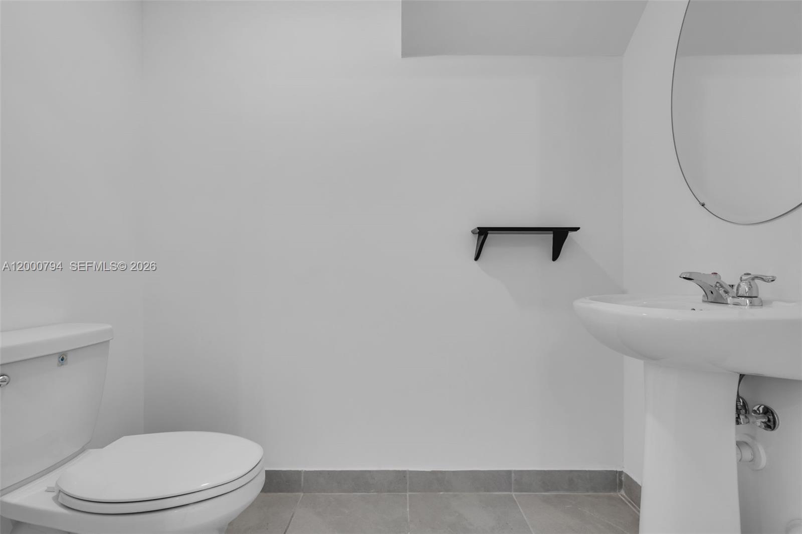 23077 Southwest 129th Place Miami, FL 33177 - Photo 21 of 43 a white toilet sitting next to a bathroom sink