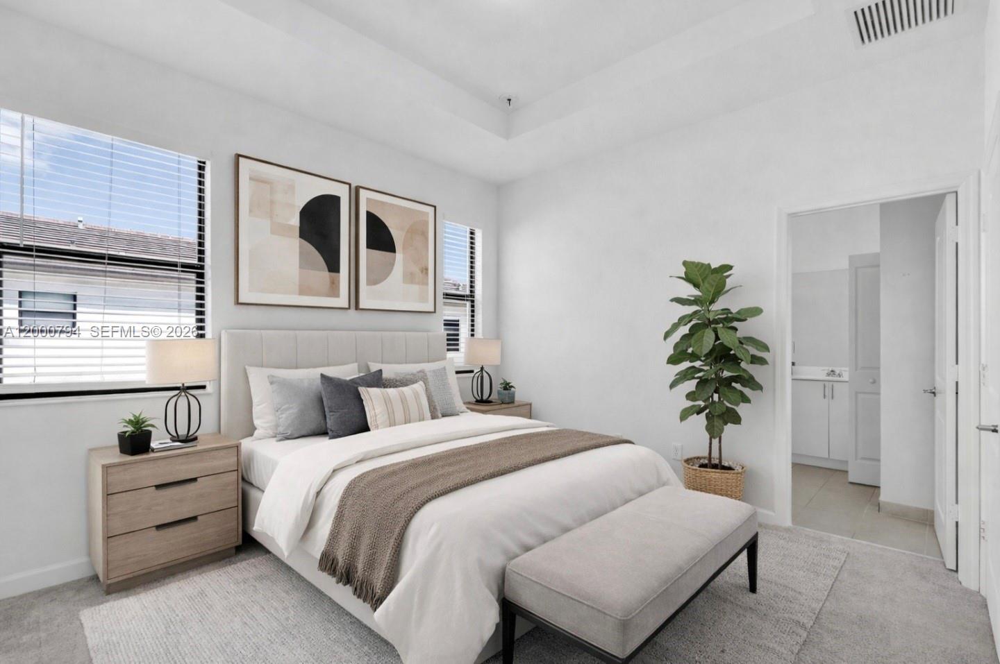 23077 Southwest 129th Place Miami, FL 33177 - Photo 22 of 43 a bedroom with a bed and a potted plant