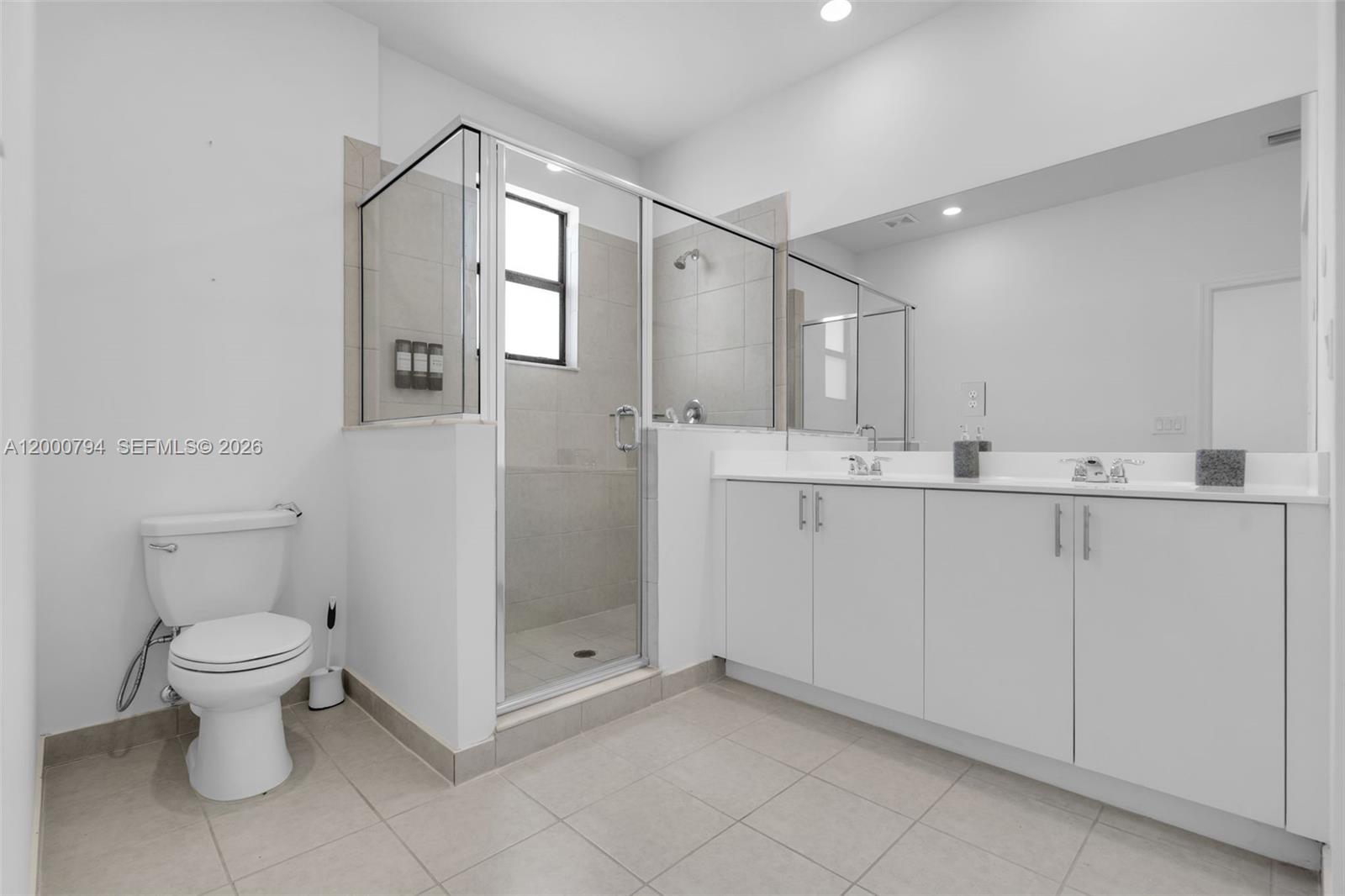 23077 Southwest 129th Place Miami, FL 33177 - Photo 27 of 43 a bathroom with a sink a toilet and shower