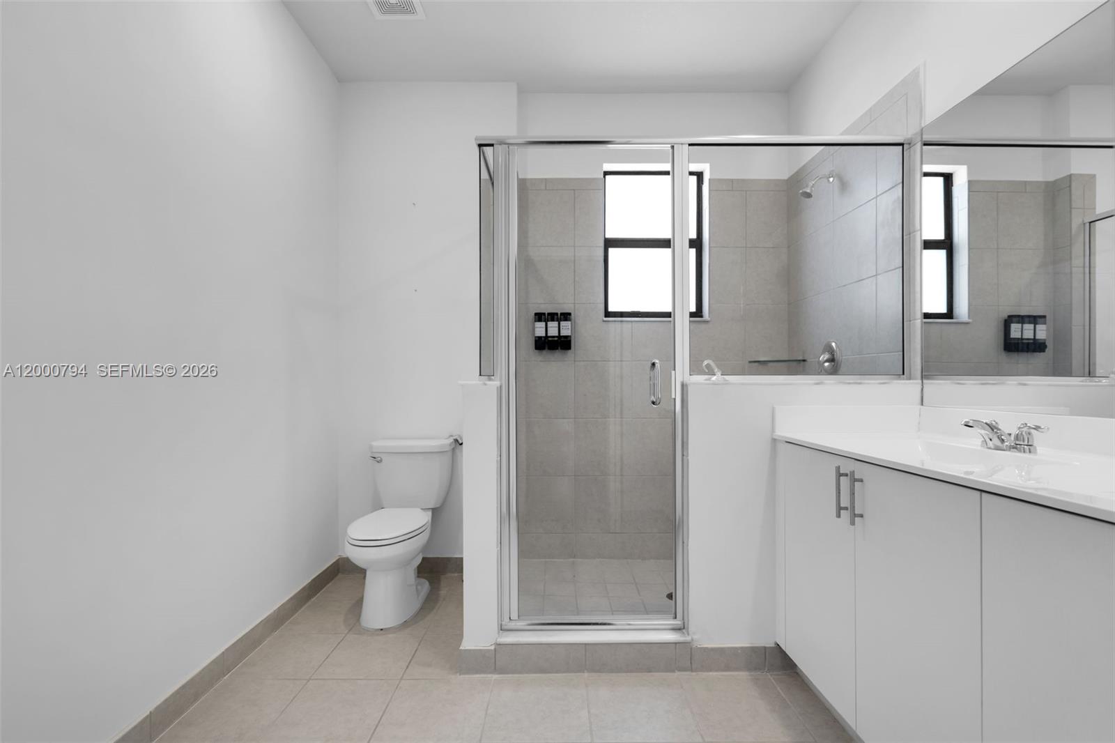 23077 Southwest 129th Place Miami, FL 33177 - Photo 28 of 43 a bathroom with a sink a toilet and shower