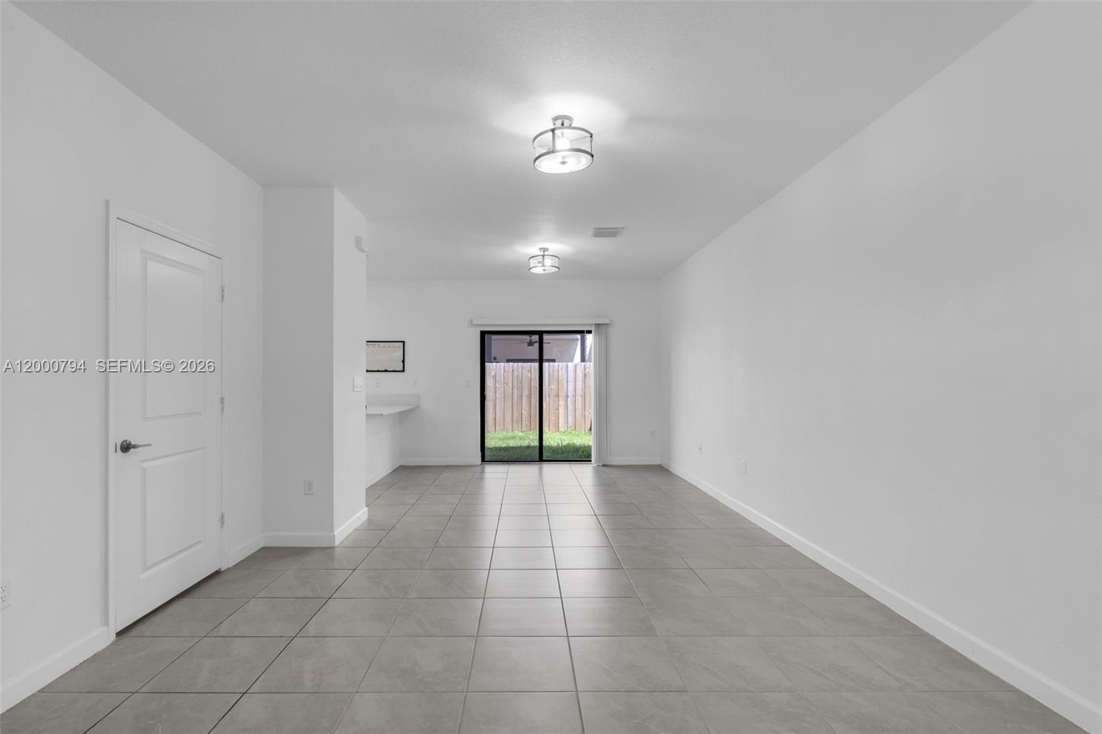 23077 Southwest 129th Place Miami, FL 33177 - Photo 6 of 43 wooden floor in an empty room with a window