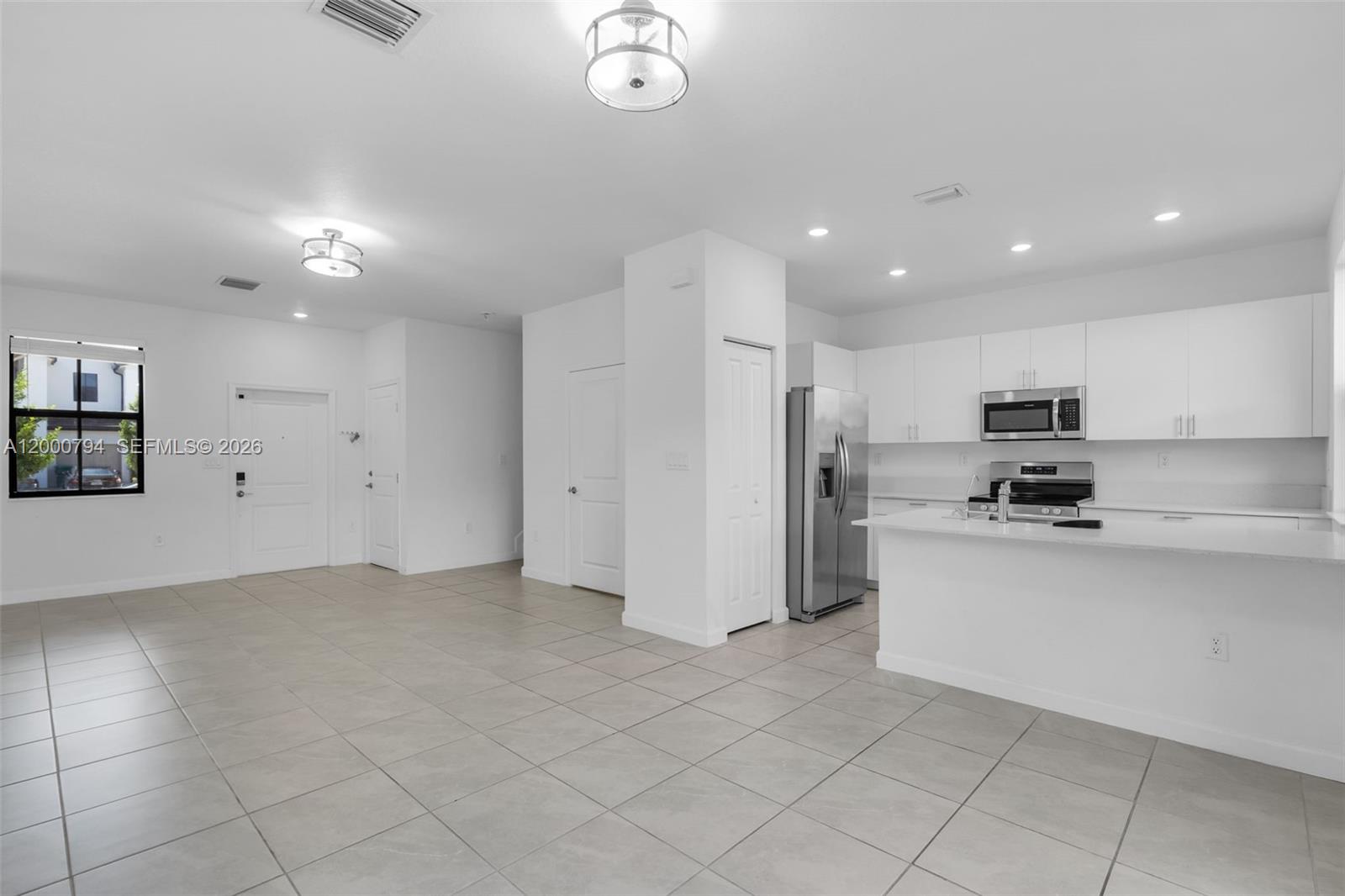 23077 Southwest 129th Place Miami, FL 33177 - Photo 8 of 43 a kitchen with stainless steel appliances granite countertop a refrigerator and a sink