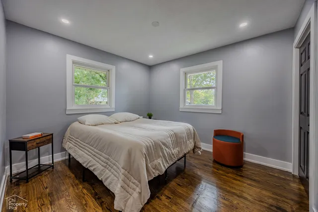 a spacious bedroom with a bed and a window