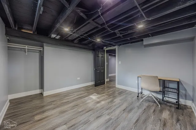 a view of a room with wooden floor and furniture