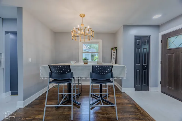 a view of a dining room with furniture wooden floor and a chandelier