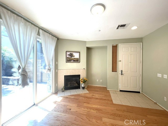 8692 East 9th Street, Unit 56 Rancho Cucamonga, CA 91730 - Photo 10 of 34 a view of an empty room with a fireplace and a window