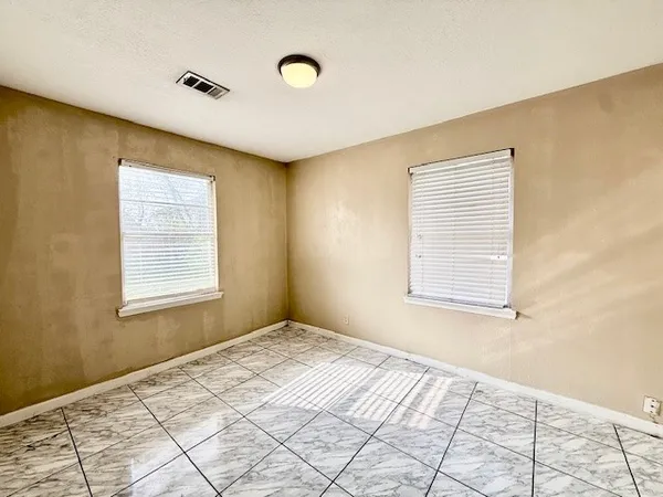 a view of an empty room and a ceiling fan