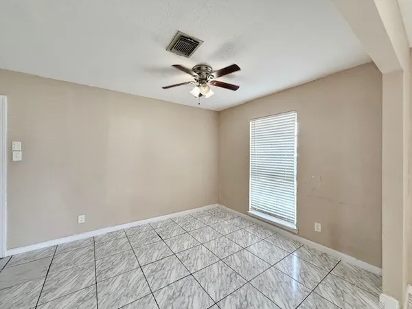 a backyard of a house with wooden floor and outdoor seating